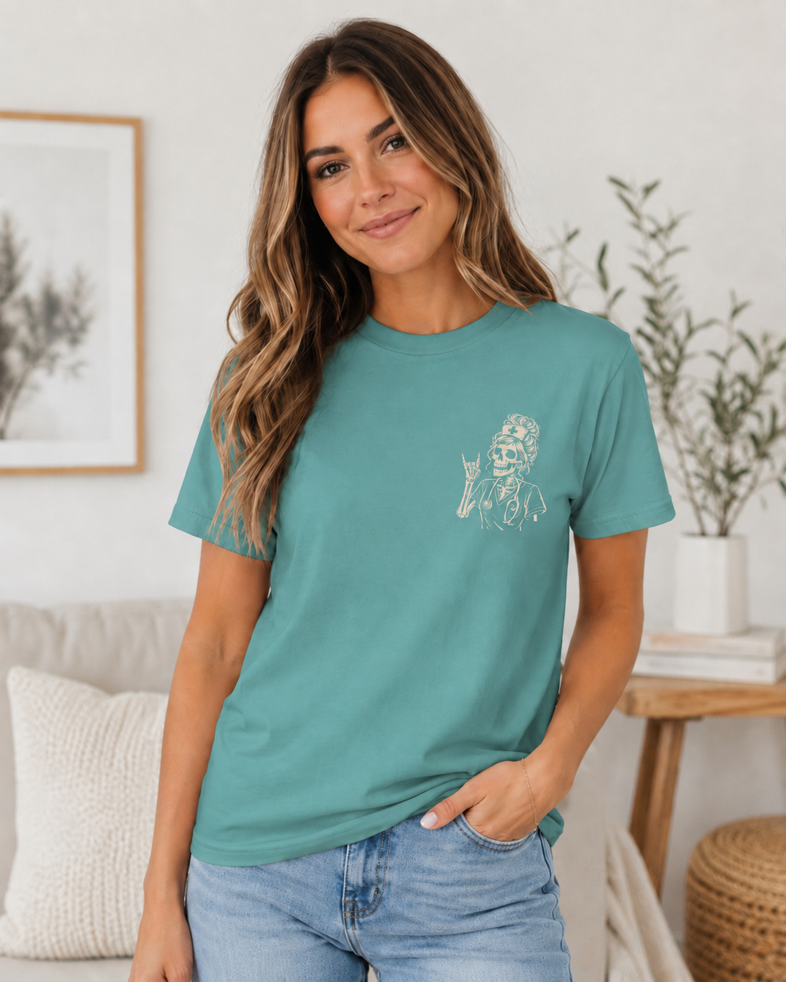 Woman wearing a teal t-shirt with a graphic design in a home setting