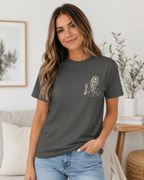 Woman wearing a dark gray t-shirt with a graphic design in a living room setting